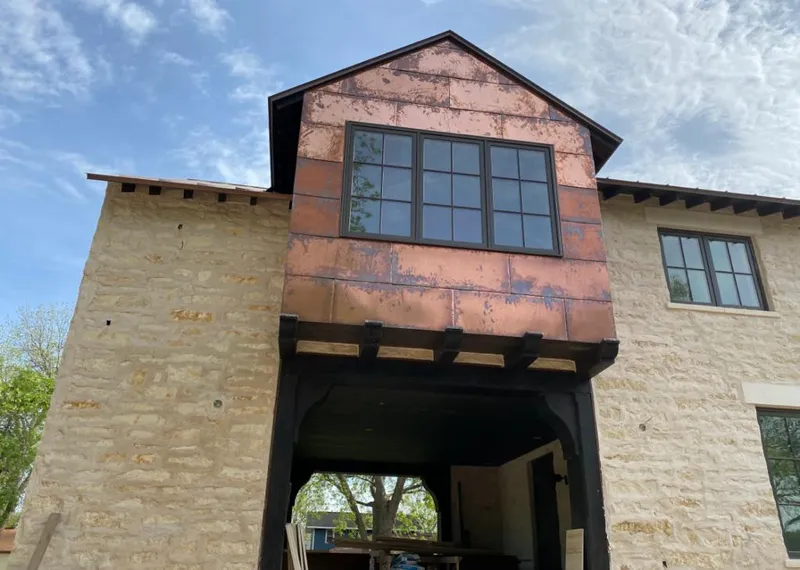 Copper metal panel facade on a stone building for Metal Roof Coating in Tarrant