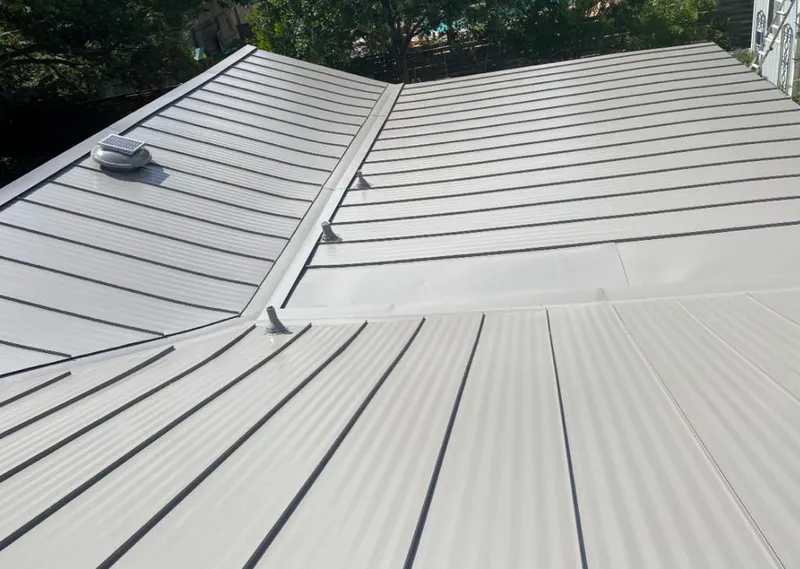 Solar attic fan installed on a metal roof for Roof Ventilation in Tarrant